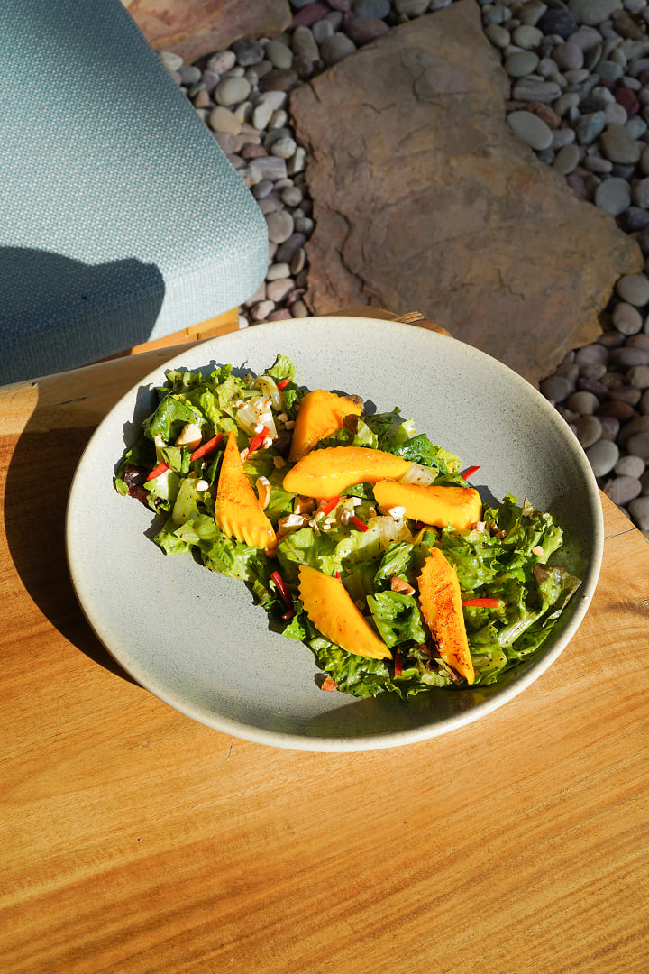 Mango salad with fresh greens and herbs at Maji Kitchen