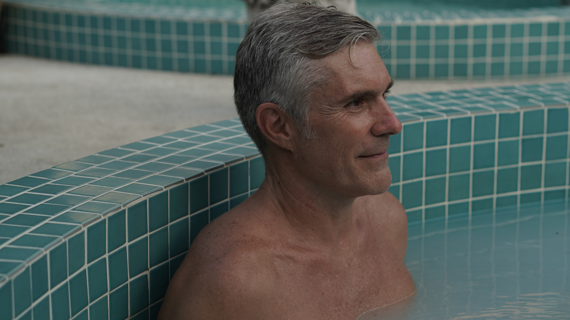Guest relaxing in the mineral hot pool at Maji Recovery Oasis